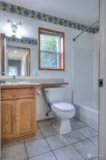 At the end of the hallway, is the main bathroom.