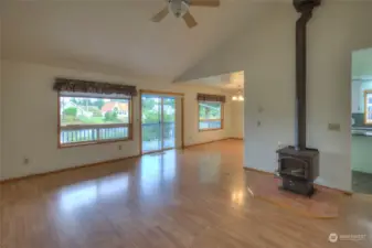 Stepping in the front door, you walk into the living room and are greeted by the wood stove and huge windows.