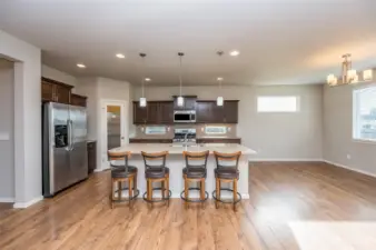 Kitchen offers quartz counters, full tiled back splash with natural light allowed through designer windows, walk in pantry and fully applianced.
