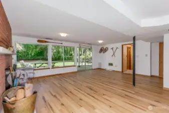 Rec room looking back toward yard.  4th bedroom and full bathroom down hallway.