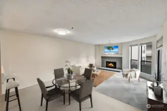 Living room with fireplace, dining, & open kitchen with eating area.