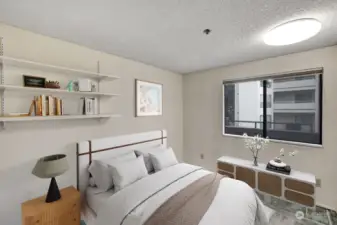 Second bedroom with built-in shelving.