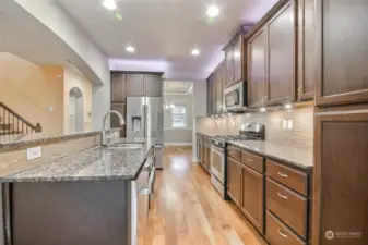 Open-concept chef’s kitchen with large island and brand-new luxury appliances.