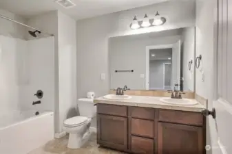 Full size bathroom upstairs with dual sinks.