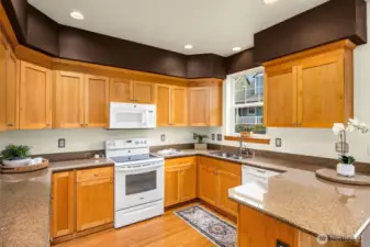 Spacious kitchen with solid wood cabinets and granite counters.