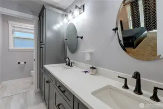 Primary Bathroom with dual vanities, quartz counters, toilet room, tub & shower, lots of counter space and storage.