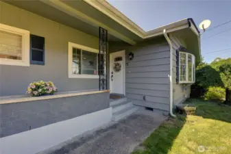 The covered front porch with planter box greets you before entering this beautifully remodeled home.