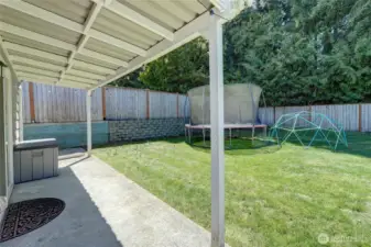 Covered patio area with slider to bonus room.