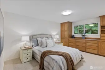 Primary bedroom with custom built-in closets.