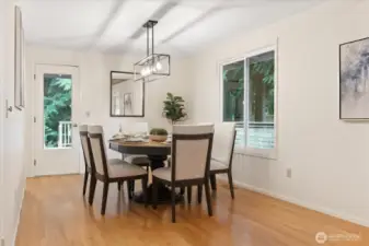 Dining room with access to expansive wooden deck and private garden.