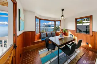Wrapped in tongue-and-groove paneling and steeped in natural light, this inviting dining room captures the essence of Pacific Northwest living. The Dutch door opens to sea air and soundscapes, while windows frame horizon-spanning views from Browns Point to the Olympics. A place to gather, reflect, and watch the tide roll in.