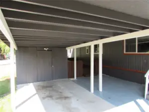STORAGE SHED IN PARKING AREA, LARGE COVERED AREA IN FRONT OF HOME, FACING SOUTH.