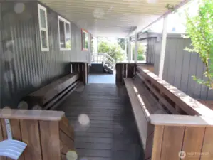 STURDY BUILT IN SEATING UNDER COVER FACES SOUTH.