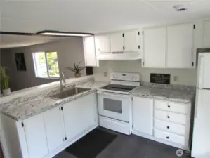 NEW COUNTERS, UPDATED CABINETS/ APPLIANCES, OPEN BAR FACES LIVING ROOM.