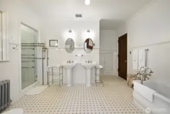 Lavish primary bathroom which has been fully restored with new plumbing behind the walls while maintaining the original nickel fixtures.