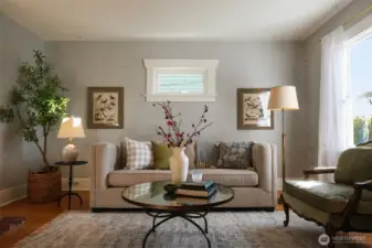 The living room is gracious and warm with hardwood floors and a brick fireplace. Open to the dining room and just a step from the kitchen.