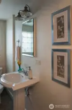 Main floor bath with tub and shower and built in storage.