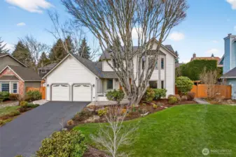 Clean curb appeal and a functional approach, including a deep driveway and a two car garage that makes daily parking and storage easy. Established plantings and a generous front lawn create a polished arrival.