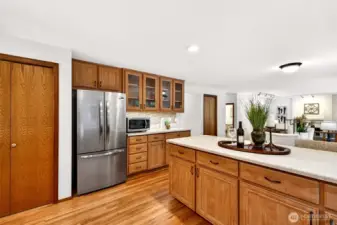 A kitchen designed for everyday ease, with abundant cabinetry, generous counter space, and an oversized peninsula that supports meal prep, serving, and casual dining. Stainless appliances and hardwood flooring pair with an open flow to the adjoining living spaces.