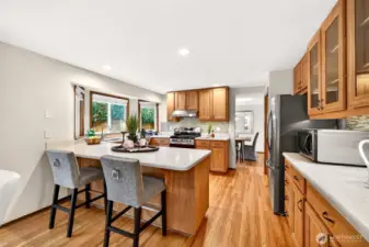 Bright and functional, with a wide workspace, deep counters, and a window over the sink that brings in natural light. The open layout keeps the kitchen connected to the main level, ideal for entertaining and staying part of the conversation.