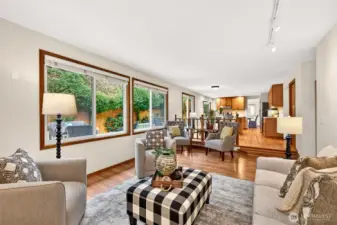 Spacious family room with an open connection back to the kitchen and dining areas, making the layout feel expansive and practical. Generous windows invite in natural light and create a peaceful outlook to the yard.