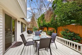 A long, versatile deck designed for easy indoor outdoor living, with direct access from the home and space to host comfortably. Mature landscaping helps create a tucked away feel and a peaceful outlook.