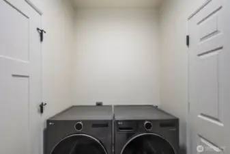 laundry room with walk-in to garage