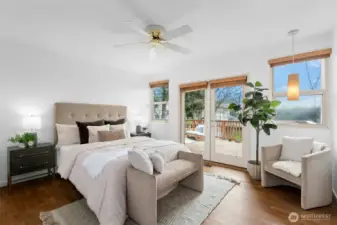 The primary suite provides a peaceful retreat with French doors leading to the deck, an updated bath, and walk-in closet