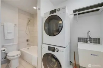 Full bath and laundry across from 3 bedrooms