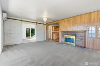 Living room looking into family room through beautiful barn doors, for privacy.