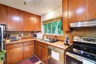 The kitchen is updated with stainless steel appliances. Plenty of counter space, so nice to have an open kitchen instead of the narrow kitchens often seen in Seattle multifamily buildings. This building lives luxuriously with each unit having it's own "home like" feel.