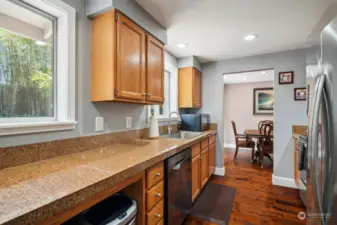 Efficient galley style kitchen with granite tile countertops!