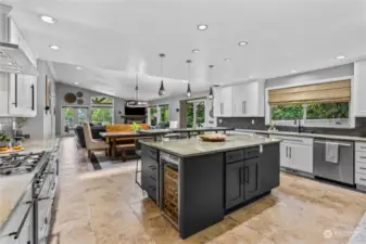 Gorgeous kitchen boasts a large island with eating space and beautiful granite countertops. Perfect space for entertaiing a crowd.  This is truly an amazing layout.