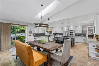 Large dining area off the kitchen has natural overhead lighting and makes this kitchen feel oh so spacious.