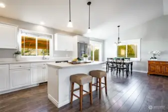 Kitchen and dining with windows facing east and looking out to backyard