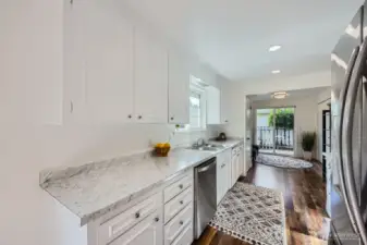 Bright & modern kitchen boasts Frigidaire Stainless Steel appliances, updated hardware, marblesque countertops and, stainless double bowl sink