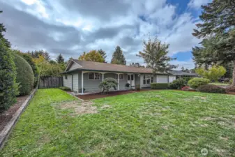 Lots of level, grassy land in front with seasonal shrubs, bushes, lined edging & flower bed.  This generous front yard creates a nice buffer of privacy & distance from the street
