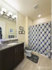 The guest bathroom has granite countertops and tile flooring. I like this detail, it elevates the entire house.