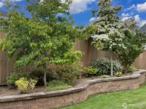 The yard includes a custom-raised garden area for herbs, vegetables, and flowers.