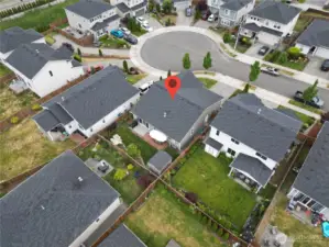 Aerial view of a fully fenced in South facing rear yard.