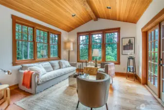 The living room offers an inviting space to gather or enjoy peaceful moments surrounded by nature.