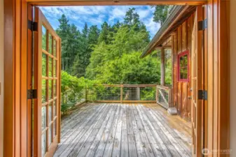 French doors in the living room open onto a spacious deck overlooking the grounds.