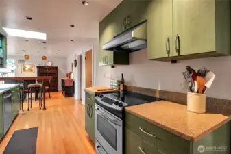 Sleek quartz surfaces add a modern touch to the kitchen.