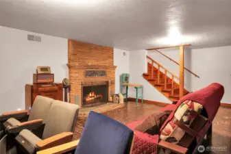 Cozy woodburning brick fireplace.