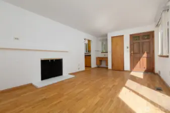 Another angle of the living room showing the built in desk and the nice solid, wood front door.