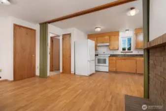 Another angle from the dining room that shows the furnace and pantry closets. The pantry is located behind the fridge and the furnace is behind the door on the left of the room.
