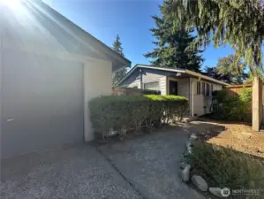 From garage to front door, this charming walkway with partial privacy fencing makes every arrival feel welcoming.