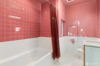 Pink themes carry throughout, with this Pink Carnation tile in the full bath on the third floor.