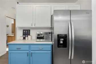 Extra countertop area offers flexibility—perfect for a coffee nook or small appliance zone