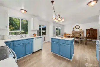 Open-concept kitchen and living room with a versatile second living space currently used as a dining room